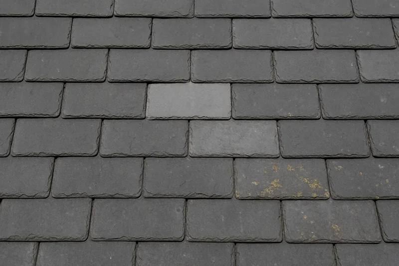 Overlapping grey slates in straight courses with one slate a shade lighter than its neighbours — slate roofing, Sydney. Illustrative example.